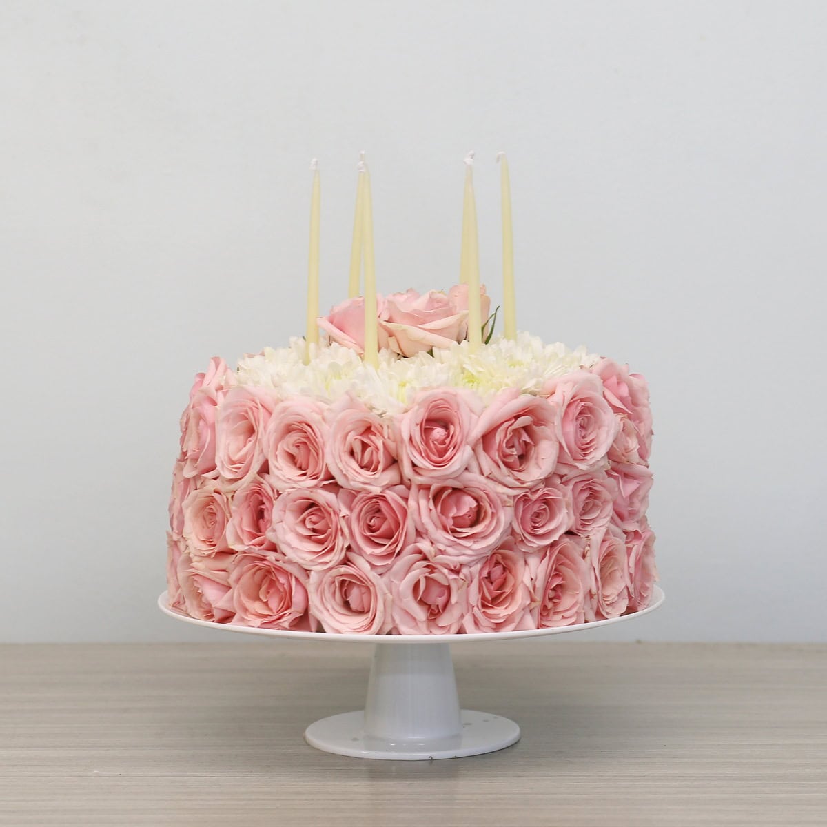floral cake arrangement with pink roses on oasis cake stand centerpiece