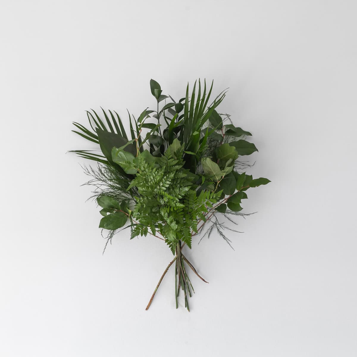 Mixed standard greens bouquet with assorted greenery stems including ruscus, ferns, palm and salal